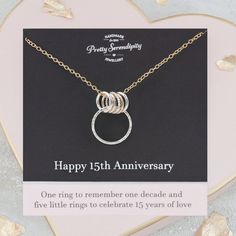 This sentimental 15th anniversary necklace combines one large ring for one decade with five smaller adjoining rings that symbolise five years, thus creating the perfect keepsake to commemorate 15 years of marriage. The special meaning behind the pendant is highlighted on a complimentary gift card bearing the message 'One ring to remember one decade and five little rings to celebrate 15 years of love'. The rings that make up this pendant are handcrafted from 925 sterling silver and 14ct gold fill Personalized Necklaces For Anniversary, Gold Necklaces For Anniversary, Happy 15th Anniversary, 15th Anniversary Gift, 15th Wedding Anniversary, Mixed Metal Necklace, Anniversary Necklace, Anniversary Gift For Wife, 15th Anniversary