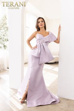 a woman in a purple dress posing for the camera