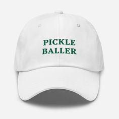 🏓 "Pickle Baller" Embroidered Baseball Cap 🏓 Elevate your game on and off the court with the "Pickle Baller" embroidered baseball cap--the perfect accessory for any dedicated pickleball player. Whether you're hitting the courts or just want to show off your love for the sport, this cap combines style, comfort, and a bit of sporty flair. Key Features: 🏓 Bold Embroidery: Show off your pickleball passion with the striking "Pickle Baller" embroidery, making it clear that you dominate the court. ? White Baseball Cap For Tennis, White Tennis Baseball Cap, White Tennis Cap, White Dad Hat With Letter Print For Sports Events, Adjustable Snapback Hats For Tennis, Adjustable Tennis Cap, Bold Embroidery, Pickleball Gifts, Sports Hat