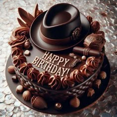 a birthday cake with chocolate decorations and a hat on top