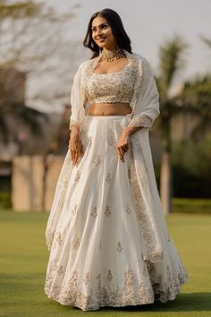 Ivory lehenga with zardozi embroidered floral motifs. Paired with blouse and dupatta.
Components:3
Pattern:Embroidered
Type of Work:Zardozi, floral
Neckline:Round
Sleeve Length:Half
Fabric:Bamberg silk, organza
Color:White
Other Details:
Back tassel tie-up
Cutwork bordered sheer dupatta
Occasion:Bride - Aza Fashions Floral Bridal Lehenga, White Blouse Designs, Ivory Lehenga, Bridle Dress, Bridesmaid Dresses Indian, Sheer Dupatta, Lehenga Bridesmaid, Wedding Frocks, Bridesmaid Lehenga