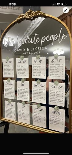 a mirror with seating cards attached to it