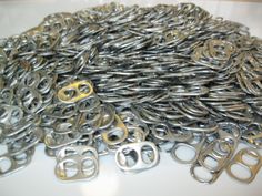 a pile of metal chains sitting on top of a white table next to each other