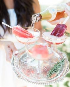 two glasses filled with different types of drinks on a tray next to another glass full of ice and watermelon