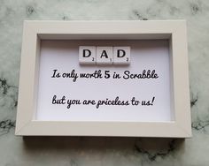 a scrabble tile frame with the words dad written on it