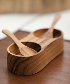 two wooden spoons in a holder on a table