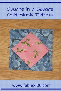 the square in a square quilt block is pink and has blue flowers on it, along with