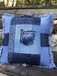 a blue jean pillow on a wooden bench