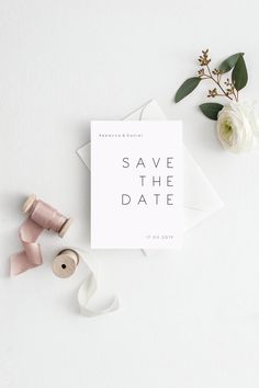 the save the date card is surrounded by ribbon, flowers and spools on white paper