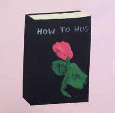 a book with the words how to hug written on it and a drawing of a person holding a flower