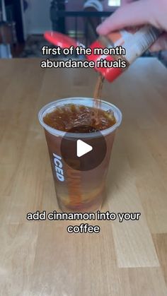 someone pouring coffee into a cup with the caption first of the month abundance rituals add cinnamon into your coffee