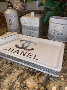 a tray with chanel logo on it sitting on a counter next to other items