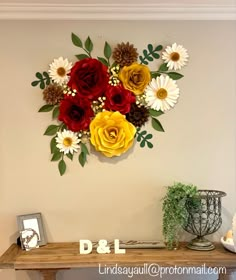 a wooden table topped with flowers on top of a wall