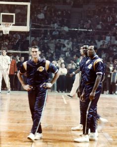 two basketball players are standing on the court