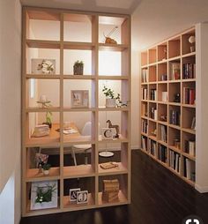 a room with many bookshelves and shelves filled with various items on it's sides