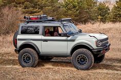 an off - road vehicle is driving through the woods