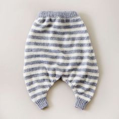 a baby's striped pants is hanging on the wall