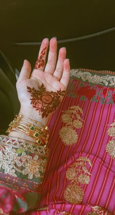 a woman's hand with henna on it