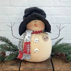 a snowman sitting on top of a wooden table