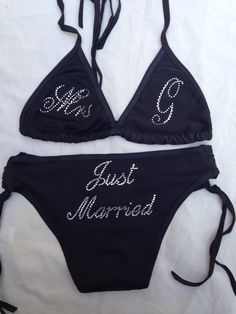 two black bikinis with the word just married written on one side and diamond embellishment