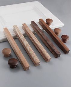 several pieces of wood sitting next to each other on a white plate and gray surface