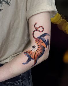 a man with a tiger tattoo on his arm