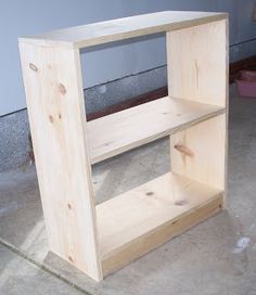 a wooden ring box sitting on top of a cement floor next to a wall with the words, access popular diy wooden ring box