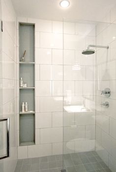 a bathroom with a shower, toilet and shelf