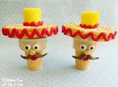 two small toy figurines with hats and mustaches on their heads are shown