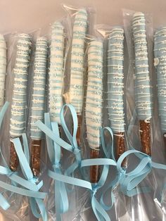 four cookies wrapped in plastic and tied with blue ribbon