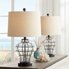 two lamps sitting on top of a wooden table