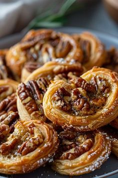 some pecans are sitting on a plate with powdered sugar and pecans in the middle