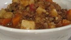 a white bowl filled with food on top of a table