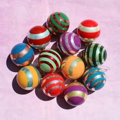 a group of colorful balls sitting on top of a pink floor next to each other