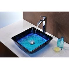 a blue square bowl sink with water running from the faucet and soap dispenser