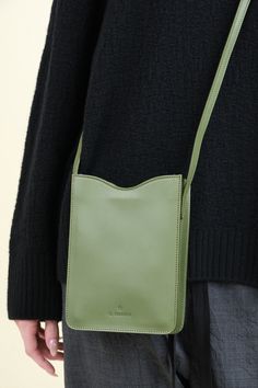 The Roseto Crossbody Bag in Cipresso is a small yet stylish bag made from bio-tanned cowhide leather. The timeless rectangular design and structured feel offer a touch of sophistication, while the adjustable shoulder strap and inside leather pocket provide convenience. The snap closure ensures security, making it the perfect accessory for any occasion. Classic Green Shoulder Bag With Mobile Phone Holder, Classic Green Shoulder Bag With Phone Holder, Classic Green Mobile Phone Bag, Chic Soft Leather Rectangular Phone Bag, Chic Rectangular Soft Leather Phone Bag, Green Rectangular Shoulder Bag For Everyday Use, Green Everyday Rectangular Shoulder Bag, Green Leather Rectangular Case Bag, Green Rectangular Bag With Smooth Grain