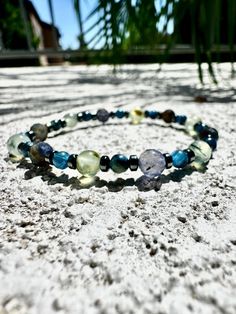 The Hematite, Kyanite, Iolite, and Prehnite crystal bracelet serves as a guiding light for intuition and grounding, a tangible representation of calm and mental clarity for the soul. By incorporating Hematite, this bracelet secures the wearer's connection to the earth, providing a stable base to expel negativity and enhance focus. Kyanite, with its vibrant blue hues, acts as a beacon of truth and alignment, inspiring the wearer to connect with their inner wisdom and communicate their truth confidently. Iolite, known as the vision stone, clears the mind's mists, offering sharpness of intuition and clarity of thought. Prehnite, a stone of quiet waters and gentle foliage, wraps the wearer in protective calm, warding off disturbances while nurturing inner peace and harmony. This bracelet is no Mystical Healing Gemstone Beads Bracelets, Adjustable Labradorite Spiritual Crystal Bracelet, Labradorite Bracelets With Natural Stones For Healing, Spiritual Fluorite Bracelets For Healing, Spiritual Fluorite Bracelet For Healing, Spiritual Fluorite Crystal Bracelet For Healing, Spiritual Healing Fluorite Bracelet, Spiritual Fluorite Bracelets With Gemstone Beads, Mystical Healing Gemstone Beads Bracelet