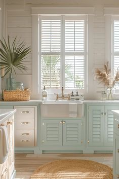 a kitchen filled with lots of white appliances and windows covered in shuttered glass shades