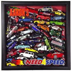 a box filled with lots of different types of toy cars in it's shadow