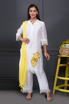 White straight long kurta with placement floral motif thread work, lace trim and fringe hem. Comes with pants and contrast tassel dupatta.
Component: 3
Embroidered
Neckine: V Neck
Sleeve Length: Three Quarter
Fabric: Kurta and Pant: Silk Chanderi; Dupatta: Chiffon
Color: White
Side slits
Tassel dupatta
Lace and fringe hem
Note: Lace may change but the look will be similar. - Aza Fashions Cotton Kurta With Embroidered Hem For Eid, Eid Cotton Kurta With Embroidered Hem, Festive Traditional Kurta With Embroidered Hem, Traditional Sets With Embroidered Hem For Eid, Festive Eid Kurta With Embroidered Hem, Traditional Eid Sets With Embroidered Hem, Traditional Festive Sets With Embroidered Hem, Festive Straight Kurta With Embroidered Hem, Spring Traditional Kurta With Tassels