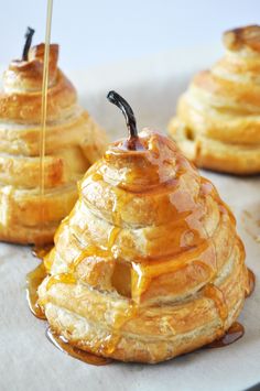 some very tasty looking desserts sitting on a tray with honey drizzled over them