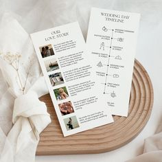 two wedding program booklets sitting on top of a wooden tray next to a white flower