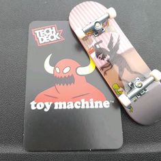 a toy machine skateboard sitting on top of a car seat cover that says tech deck