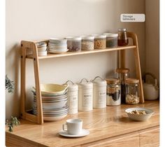 a wooden shelf filled with dishes and cups