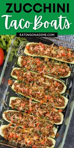 zucchini taco boats in a baking dish with tomatoes and lettuce