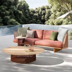 a couch and table on a patio with trees in the backgroung area