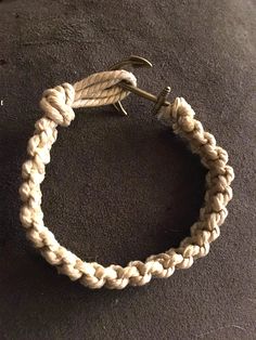 a white rope bracelet with a metal hook