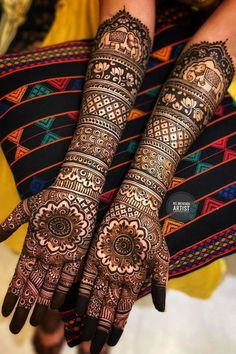 two hands with henna designs on them