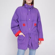 Retro vintage 80s/90s long windbreaker jacket in purple with red color blocked trim. It has snaps up the front, and a drawstring at the waist and collar. Fits oversize. Measurements and Condition:    Fits like: Labeled medium (fits oversize), could work on larger sizes Fabric: Poly/cotton shell, with nylon lining Brand: Current Seen Condition: Excellent   Length: 32" Chest: 47" Waist: 47" - cinches slightly with drawstring Shoulders (seam to seam): 21" Sleeve: 24" uncuffed   Shown on a 5'9" mode Purple Streetwear Windbreaker With Pockets, Casual Purple Outerwear With Drawstring Hood, Retro Purple Windbreaker For Fall, Casual Purple Windbreaker With Pockets, 90s Style Long Sleeve Purple Outerwear, 90s Style Purple Long Sleeve Outerwear, Sporty Purple Windbreaker With Pockets, Vintage Purple Outerwear For Outdoor, Purple Long Sleeve 90s Outerwear