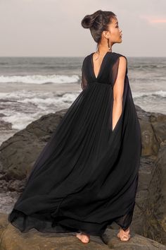 Black long gown with V-neckline in chiffon base with pleated details all-over.
Component: 1
Pattern: Solid
Neckline: V-Neck
Sleeve Type: Sleeveless
Fabric: 100% Chiffon
Color: Black
Other Details: 
Back V-neck
Pleated detailing
Occasion: Party - Aza Fashions Sheer V-neck Maxi Dress For Evening, Sheer V-neck Maxi Dress For Formal Occasions, Black Silk Chiffon Maxi Evening Dress, Elegant Silk Chiffon V-neck Dress, Chiffon V-neck Gown For Gala, Sheer Silk Chiffon V-neck Dress, Chiffon V-neck Pleated Maxi Dress, Chic Silk Chiffon V-neck Dress, Chic Black Silk Chiffon Maxi Dress